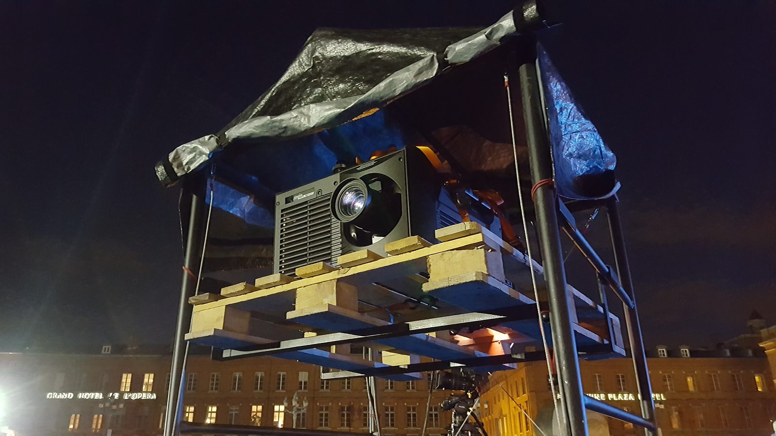 Drive-in movie screening with cars in front of a large inflatable screen